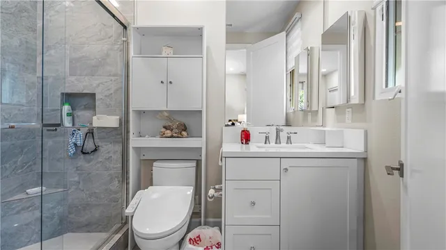 a bedroom with a bed and a flat tv screen on dresser