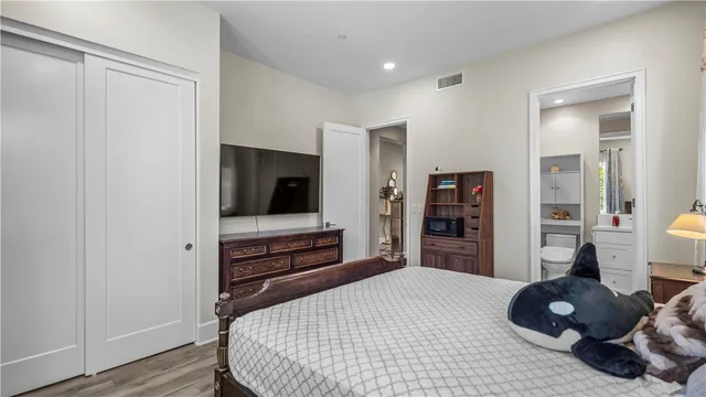 a bedroom with a bed and wooden floor