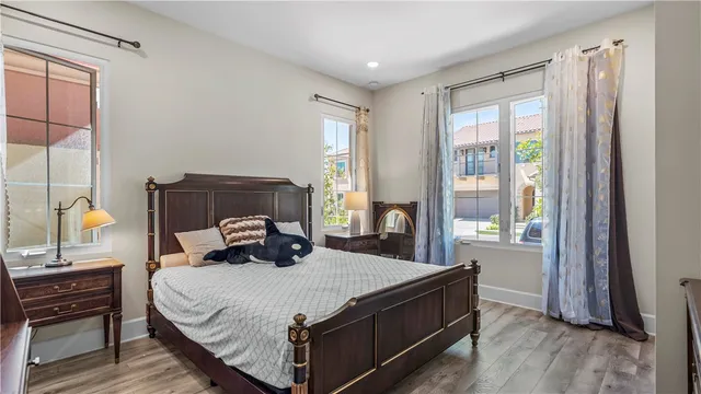 a view of a hallway with wooden floor and windows