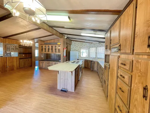 a bedroom with bed and large windows