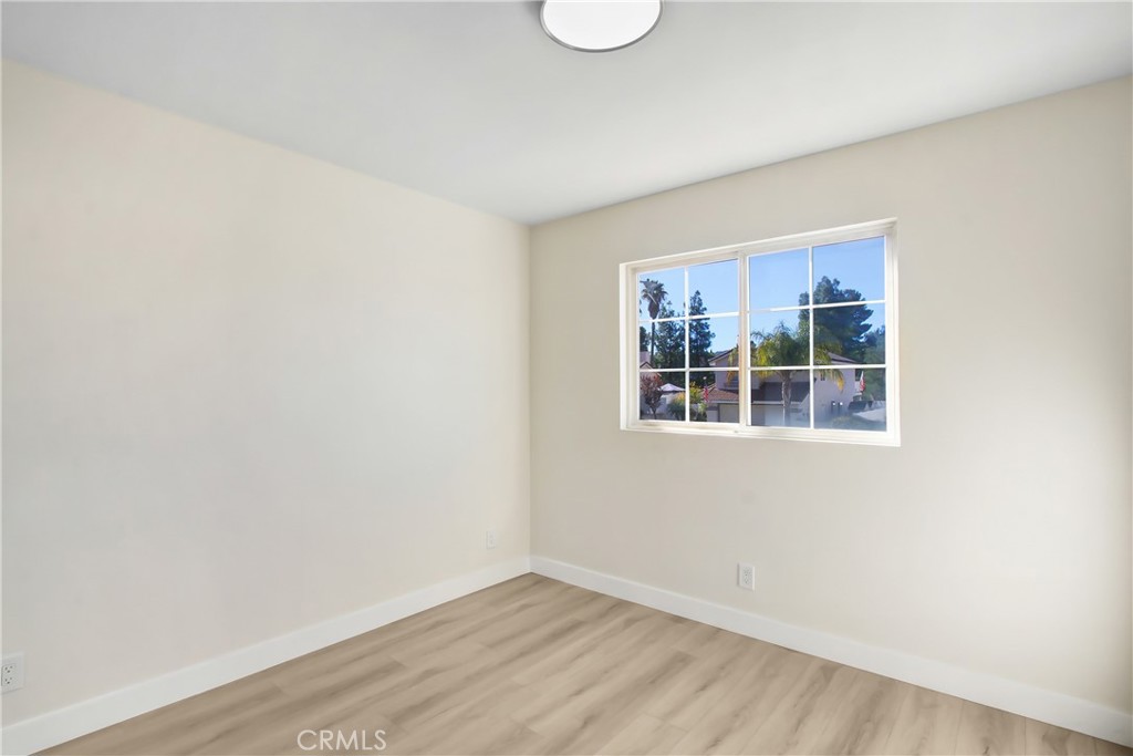 44738 Corte Gutierrez Temecula, CA 92592 - Photo 11 of 24 a view of an empty room with wooden floor and a window