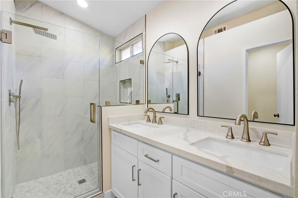 44738 Corte Gutierrez Temecula, CA 92592 - Photo 18 of 24 a bathroom with a double vanity sink mirror and shower