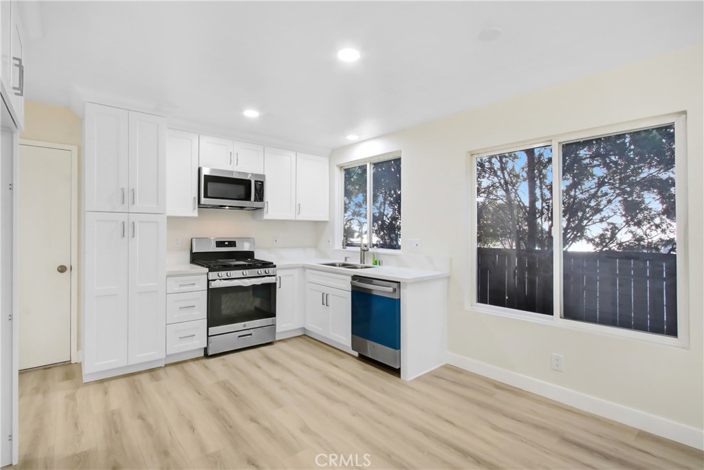 44738 Corte Gutierrez Temecula, CA 92592 - Photo 20 of 24 a kitchen with granite countertop a refrigerator stove top oven and sink