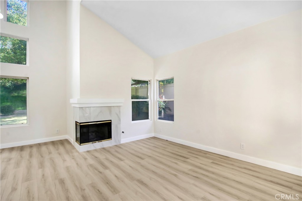 44738 Corte Gutierrez Temecula, CA 92592 - Photo 6 of 24 a view of empty room with wooden floor and fireplace