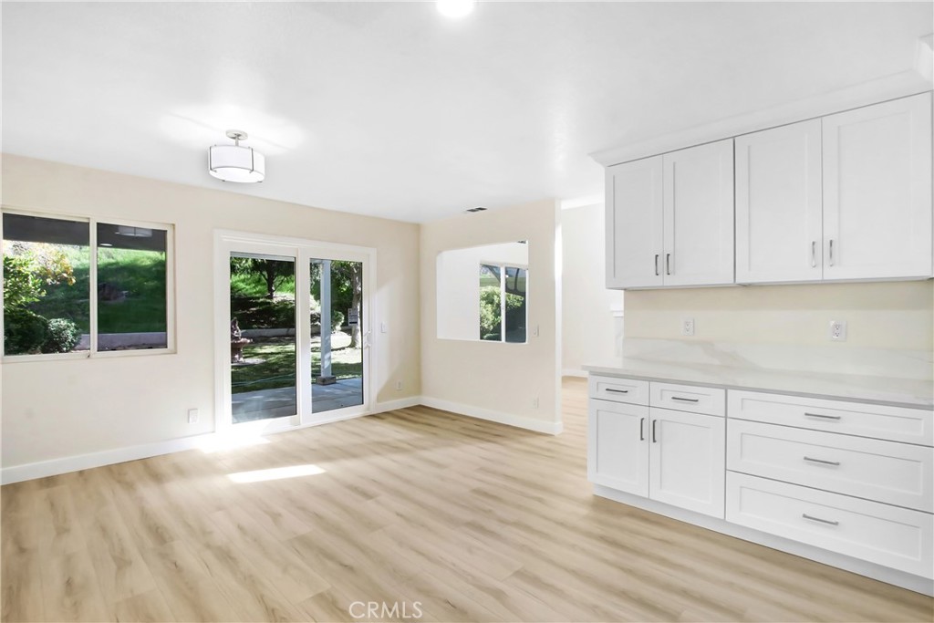 44738 Corte Gutierrez Temecula, CA 92592 - Photo 9 of 24 a view of a kitchen with wooden floor and cabinets