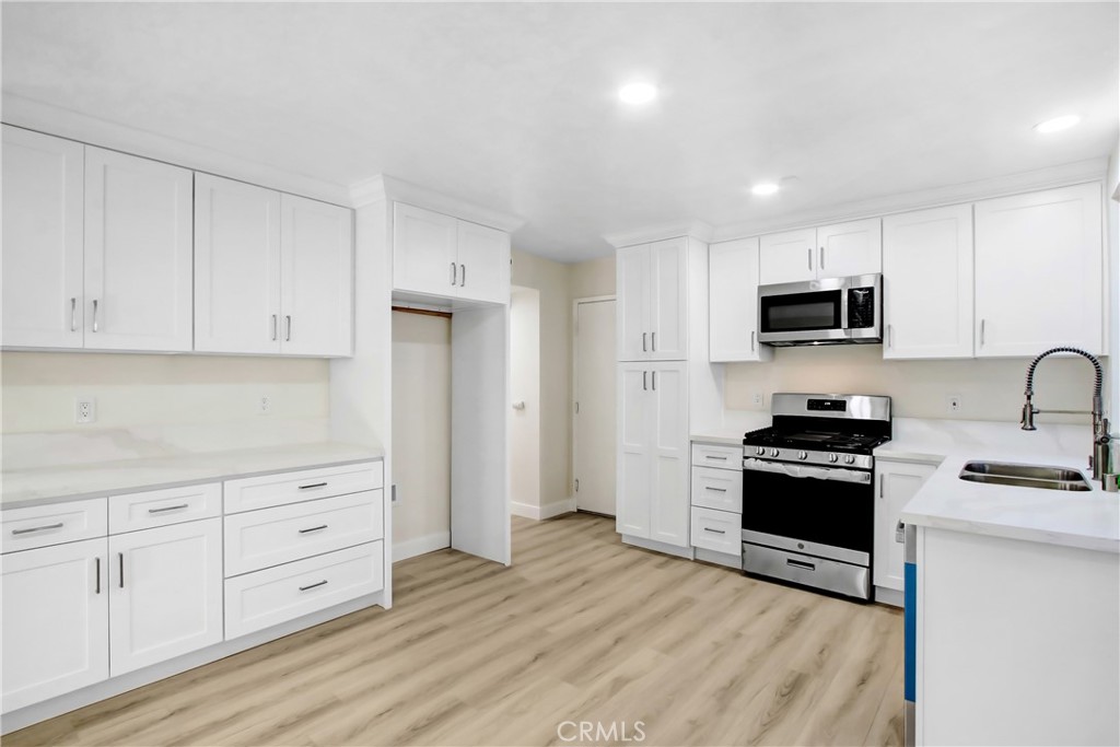 44738 Corte Gutierrez Temecula, CA 92592 - Photo 10 of 24 a kitchen with granite countertop a stove a sink and a refrigerator