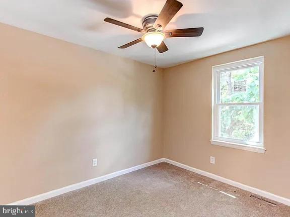 1309 East Madison Street Baltimore, MD 21205 - Photo 16 of 20 an empty room with a window and a fan