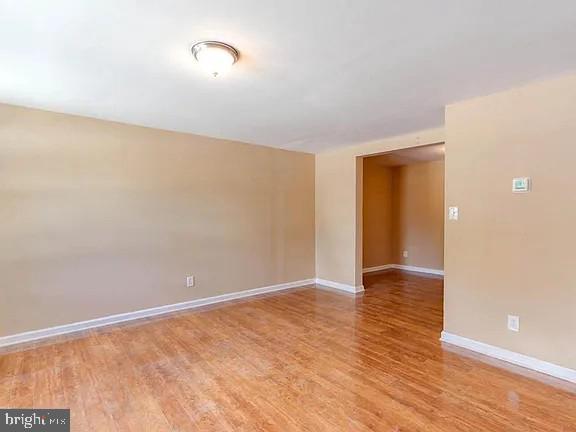 1309 East Madison Street Baltimore, MD 21205 - Photo 4 of 20 a view of an empty room with wooden floor