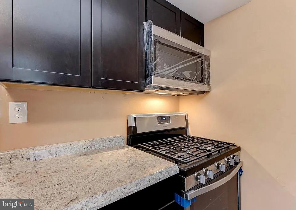 1309 East Madison Street Baltimore, MD 21205 - Photo 6 of 20 a stove top oven sitting inside of a kitchen
