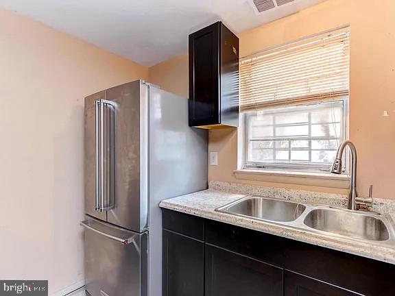 1309 East Madison Street Baltimore, MD 21205 - Photo 9 of 20 a kitchen with stainless steel appliances granite countertop a refrigerator and a sink