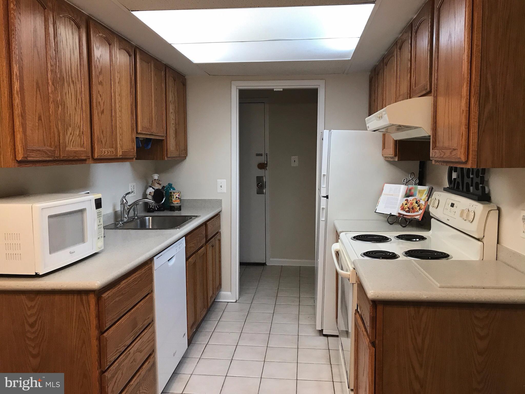 11629 Stoneview Square, Unit 21C Reston, VA 20191 - Photo 2 of 30 a kitchen with a sink cabinets and appliances