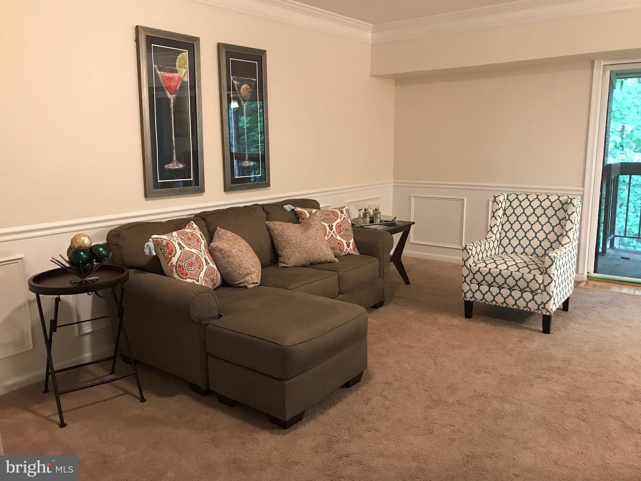 11629 Stoneview Square, Unit 21C Reston, VA 20191 - Photo 12 of 30 a living room with furniture and a window