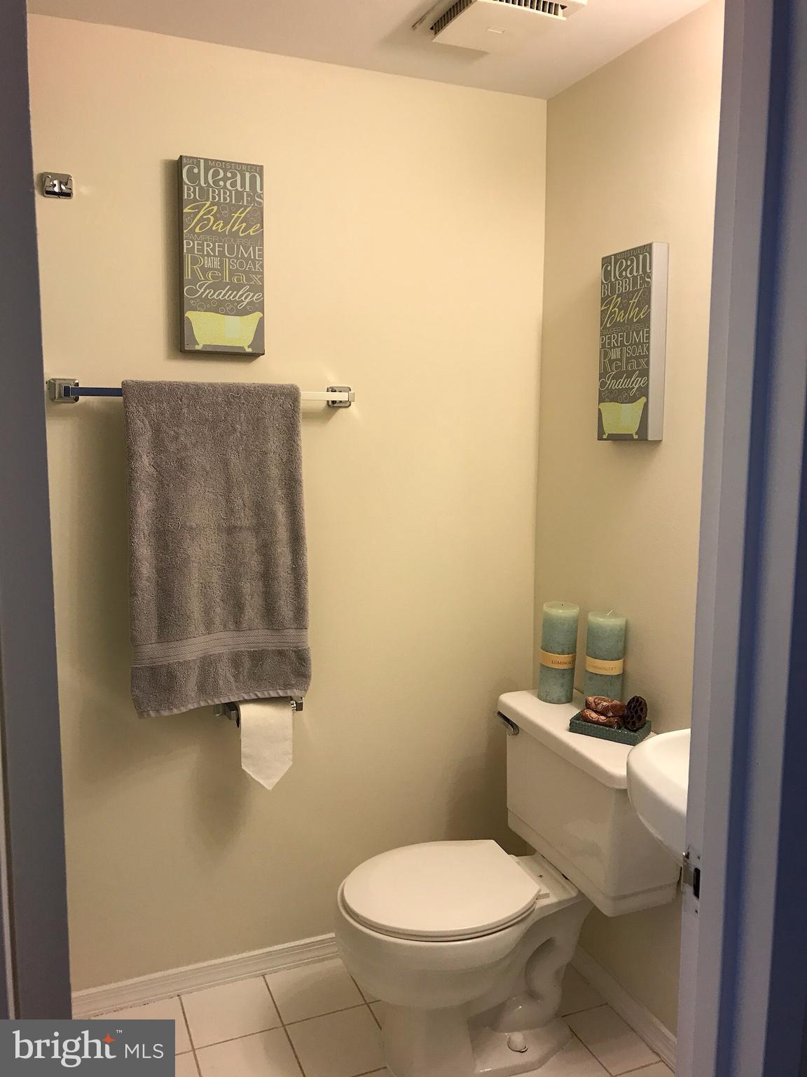 11629 Stoneview Square, Unit 21C Reston, VA 20191 - Photo 17 of 30 a white toilet sitting next to a bathroom sink