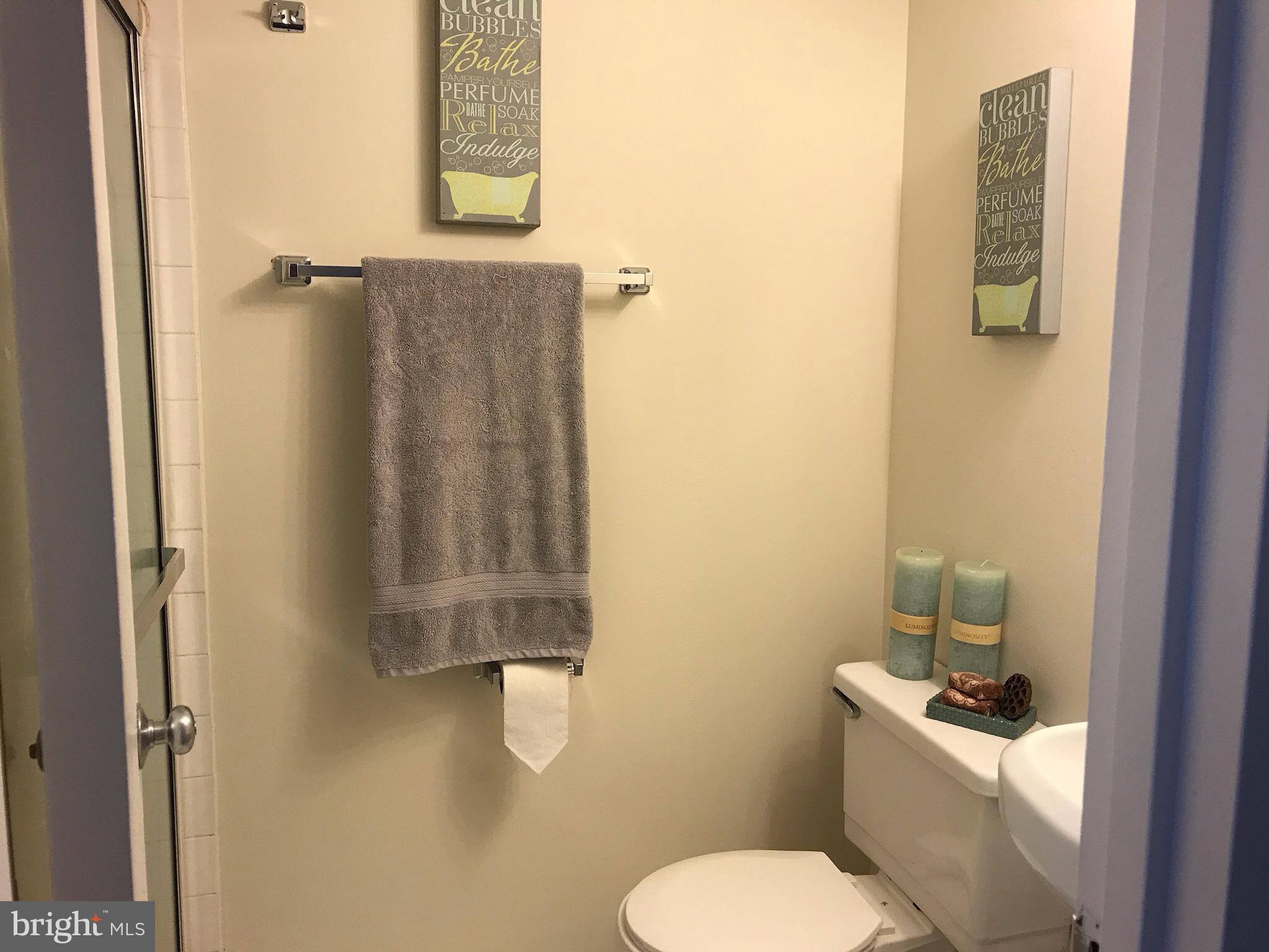 11629 Stoneview Square, Unit 21C Reston, VA 20191 - Photo 18 of 30 a bathroom with a toilet sink and mirror