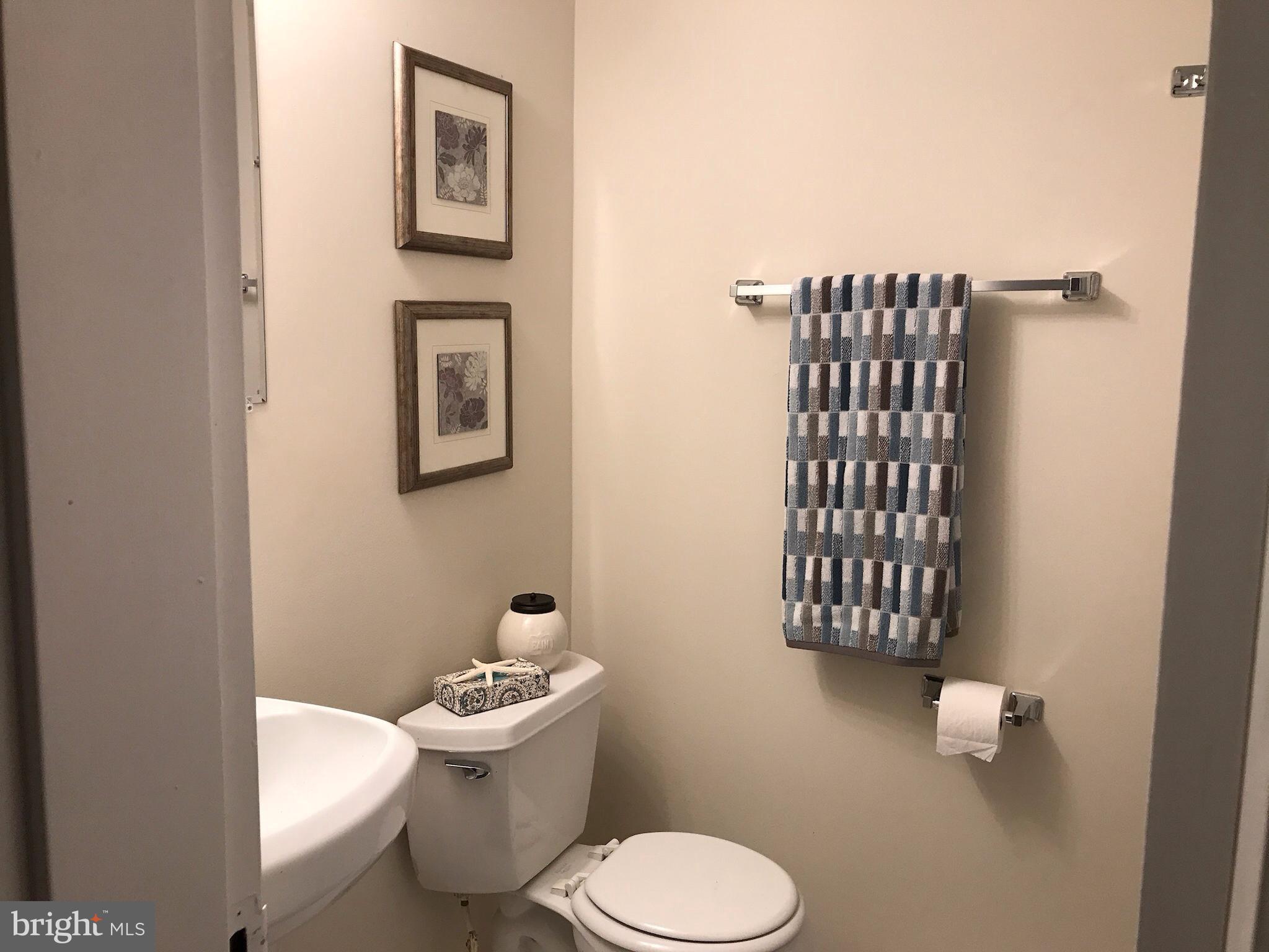 11629 Stoneview Square, Unit 21C Reston, VA 20191 - Photo 24 of 30 a white toilet sitting next to a bathroom sink