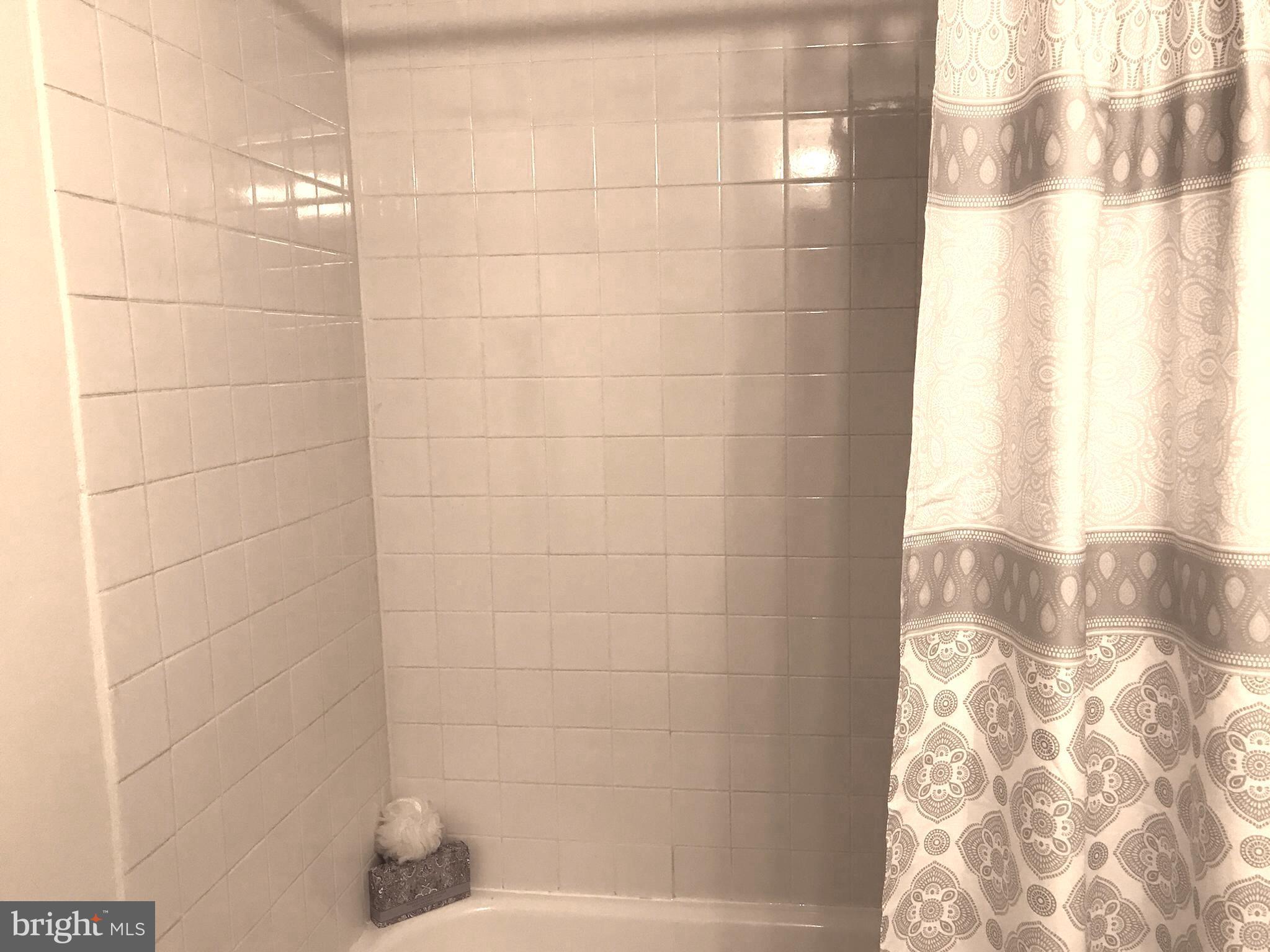 11629 Stoneview Square, Unit 21C Reston, VA 20191 - Photo 25 of 30 a bathroom with a bathtub and shower