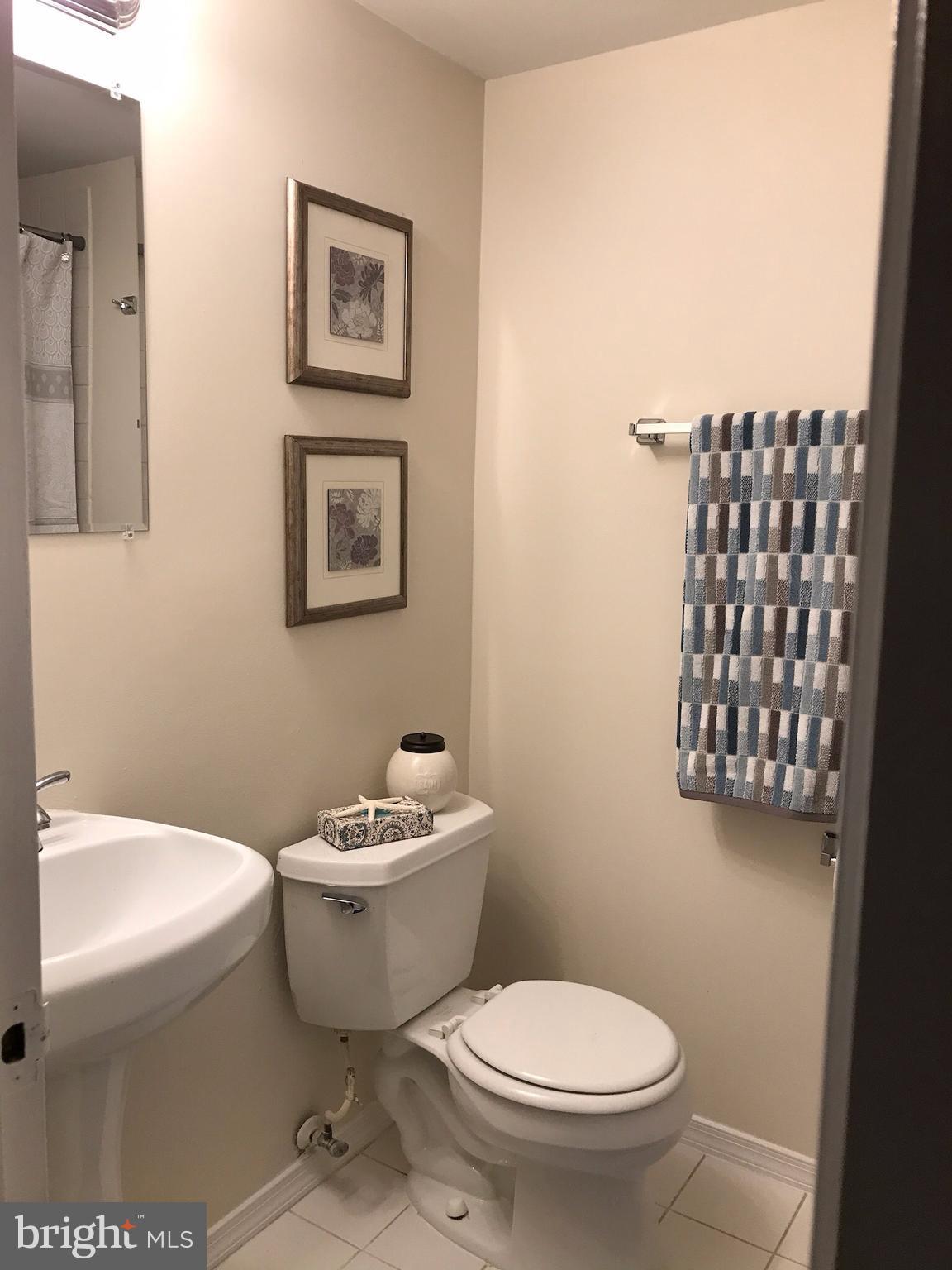11629 Stoneview Square, Unit 21C Reston, VA 20191 - Photo 26 of 30 a white toilet sitting next to a bathroom sink