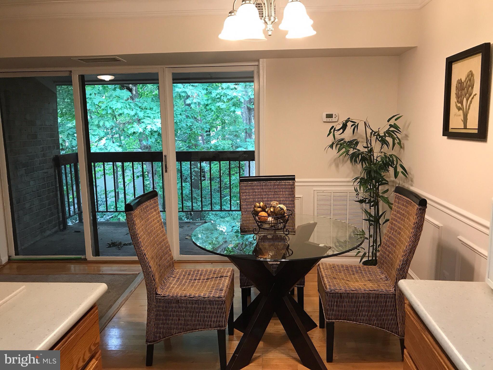 11629 Stoneview Square, Unit 21C Reston, VA 20191 - Photo 6 of 30 a view of a dining room with furniture window and outside view