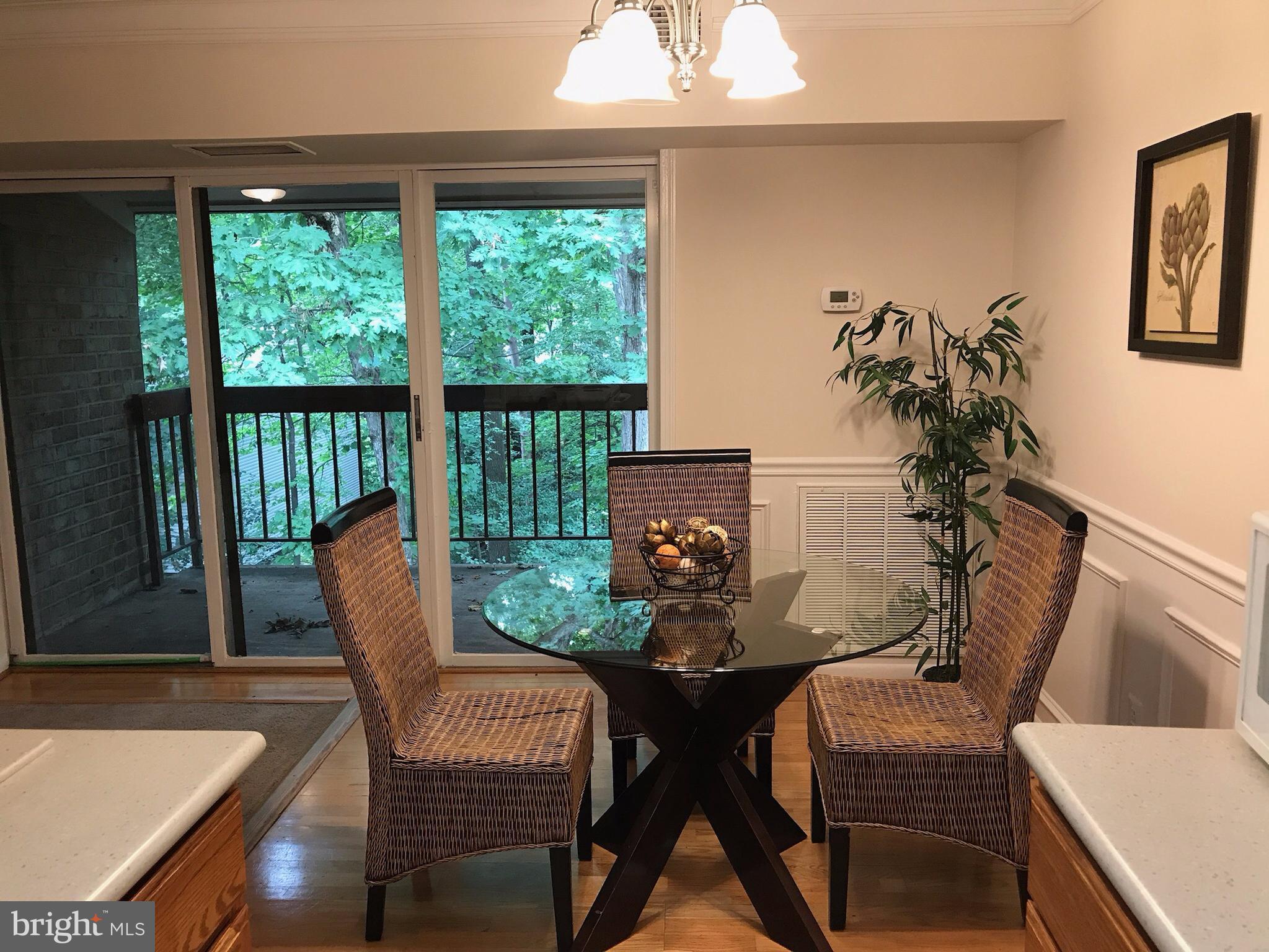 11629 Stoneview Square, Unit 21C Reston, VA 20191 - Photo 9 of 30 a living room with furniture and a potted plant