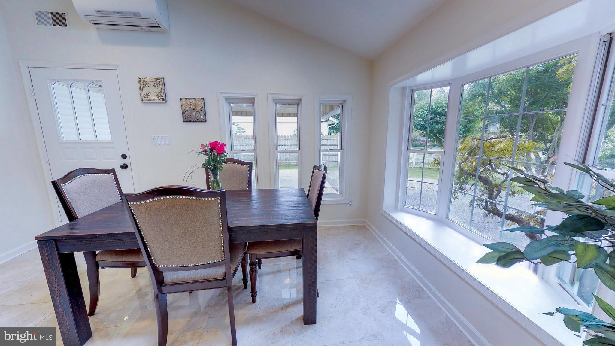 521 Beaumont Road Silver Spring, MD 20904 - Photo 10 of 30 a view of a dining room with furniture and a potted plant
