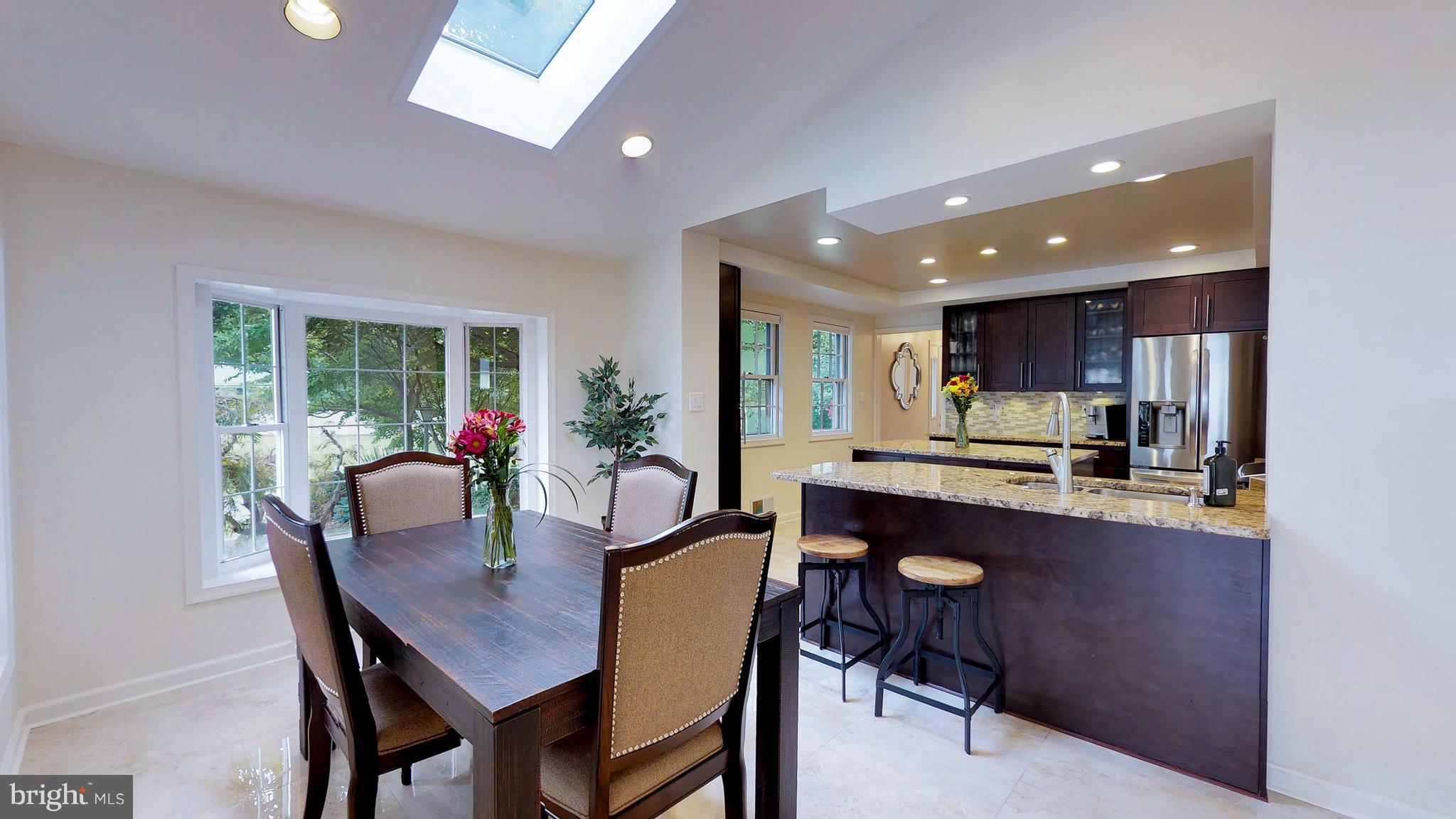 521 Beaumont Road Silver Spring, MD 20904 - Photo 11 of 30 a dining room with kitchen island a table and chairs