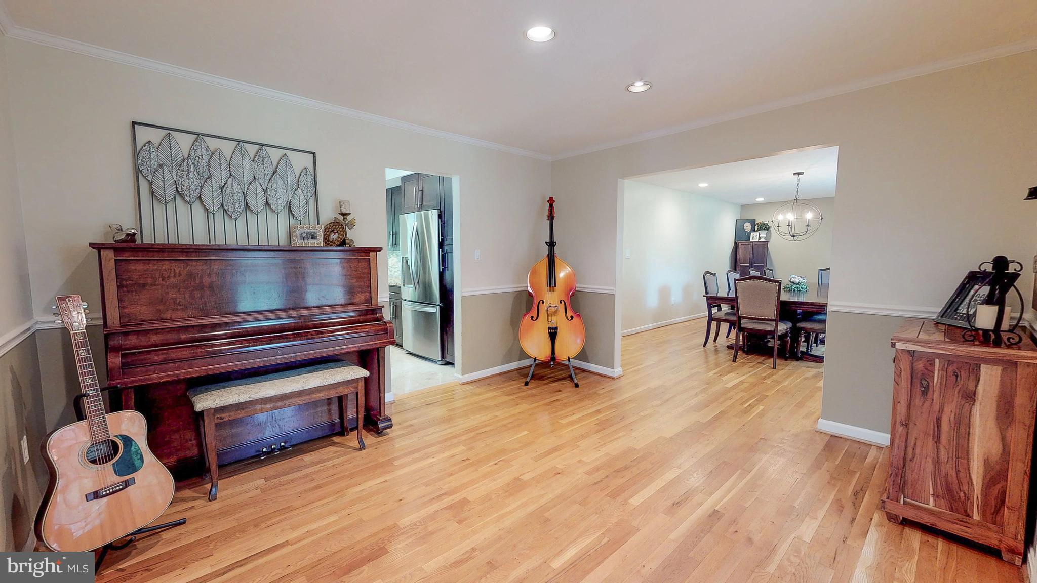 521 Beaumont Road Silver Spring, MD 20904 - Photo 15 of 30 a living room with furniture a wooden floor and a flat screen tv
