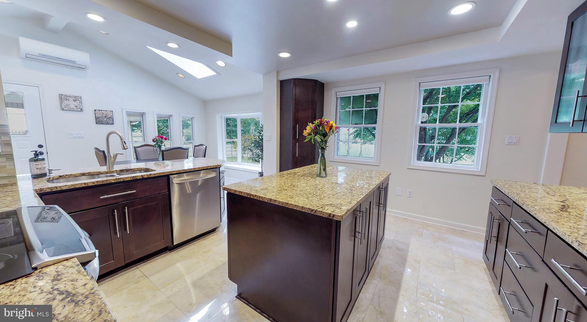 521 Beaumont Road Silver Spring, MD 20904 - Photo 7 of 30 a kitchen with granite countertop cabinets a sink and a refrigerator