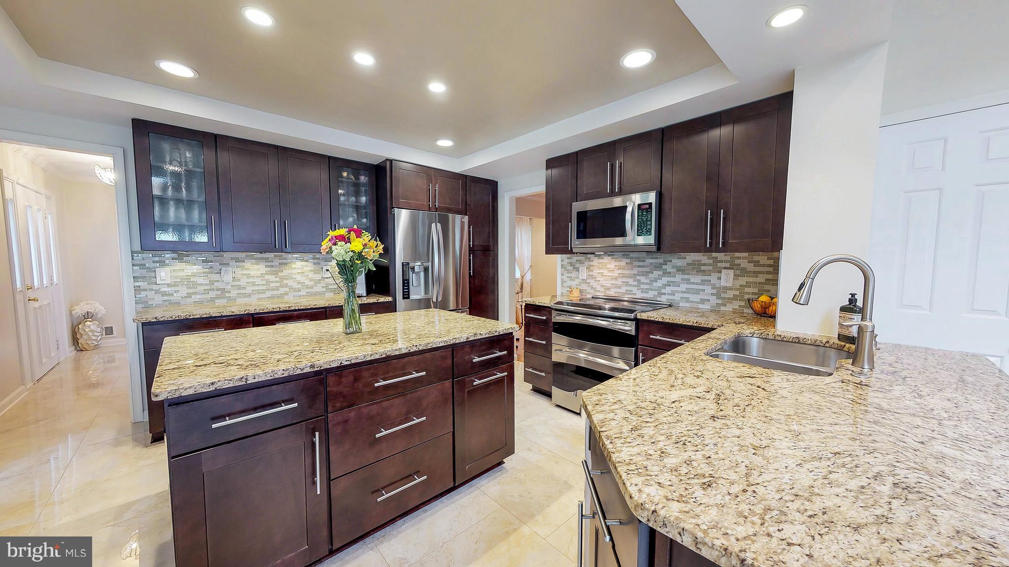 521 Beaumont Road Silver Spring, MD 20904 - Photo 8 of 30 a kitchen with stainless steel appliances granite countertop wooden cabinets and sink