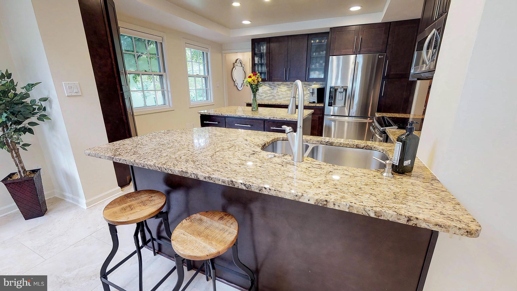 521 Beaumont Road Silver Spring, MD 20904 - Photo 9 of 30 a kitchen with stainless steel appliances granite countertop a sink refrigerator and cabinets