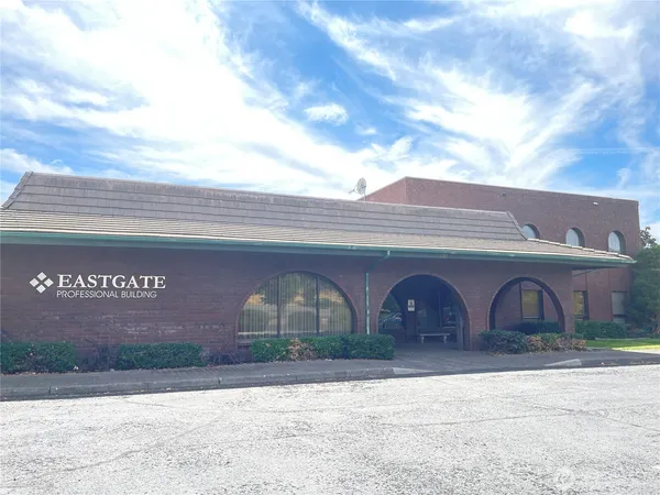 a front view of building with parking