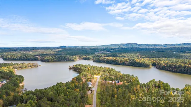 an aerial view of residential building with outdoor space and lake view