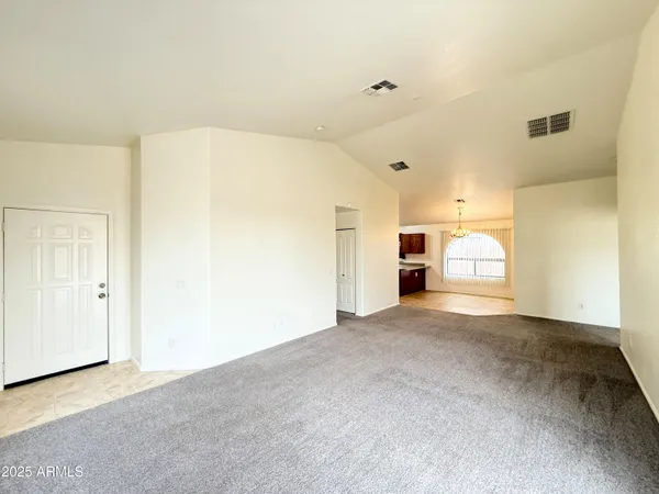 a view of a big room with closet and windows