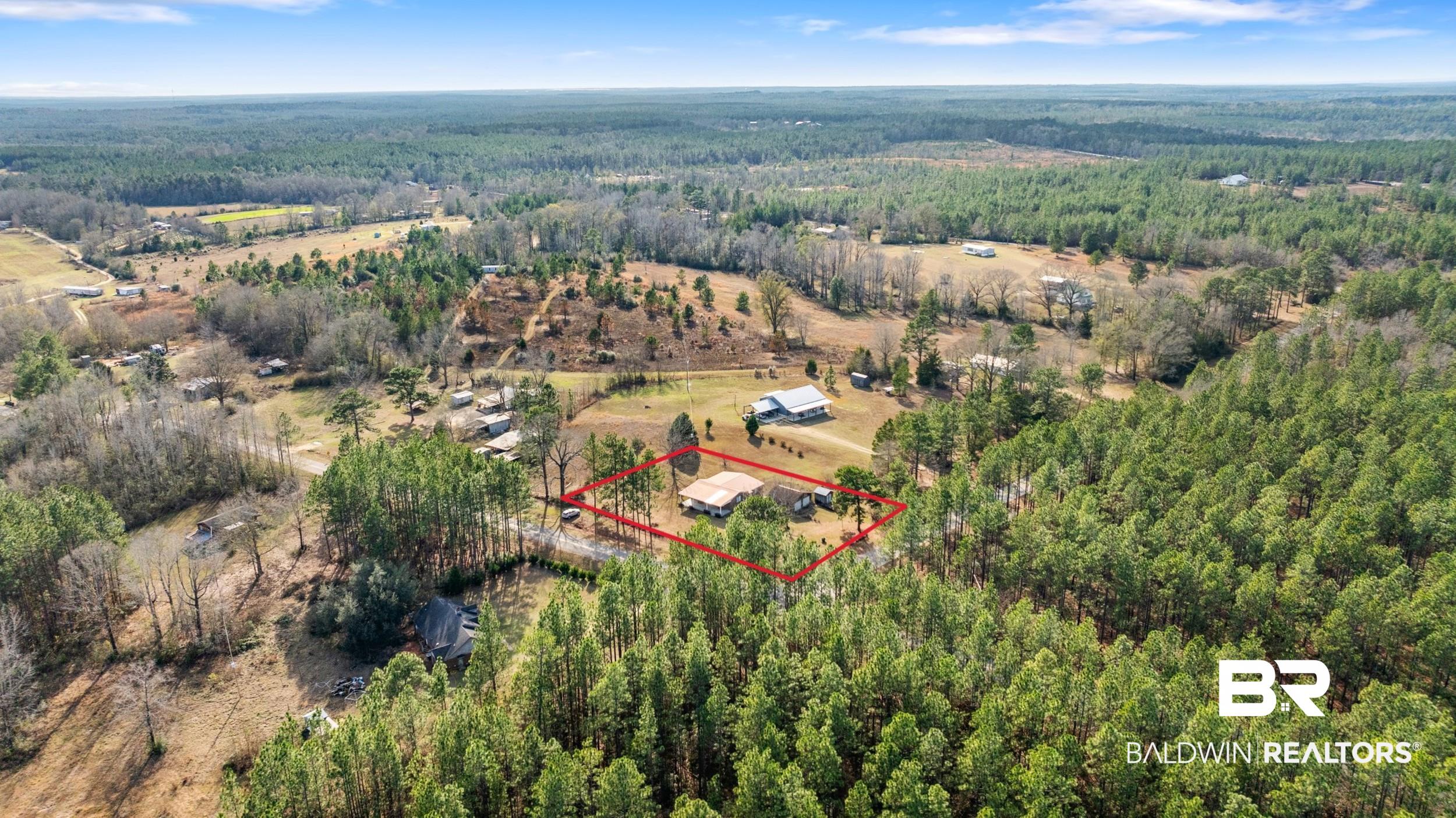 57623 Mary Hadley Road Perdido, AL 36562 - Photo 32 of 34 Aerial view of property and surrounding area featuring property parcel outlined and a heavily wooded area