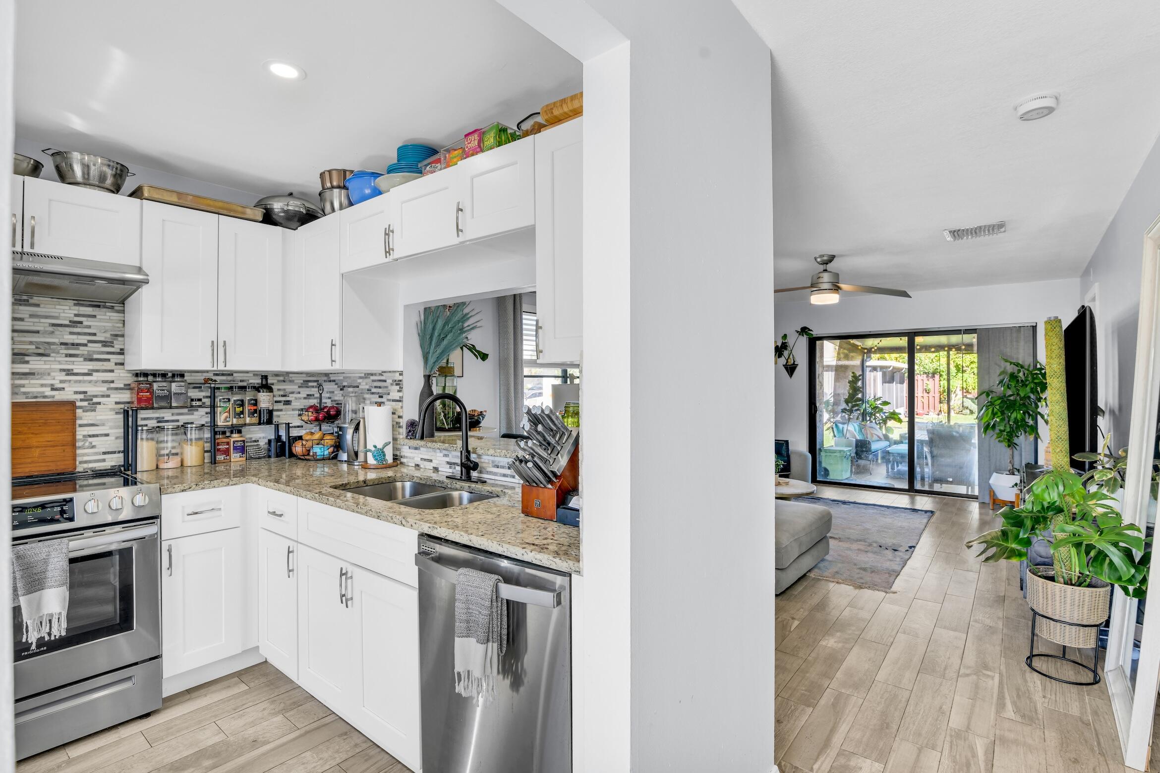 5347 Tennis Lane, Unit 5347 Delray Beach, FL 33484 - Photo 12 of 41 a kitchen with a sink stove and cabinets