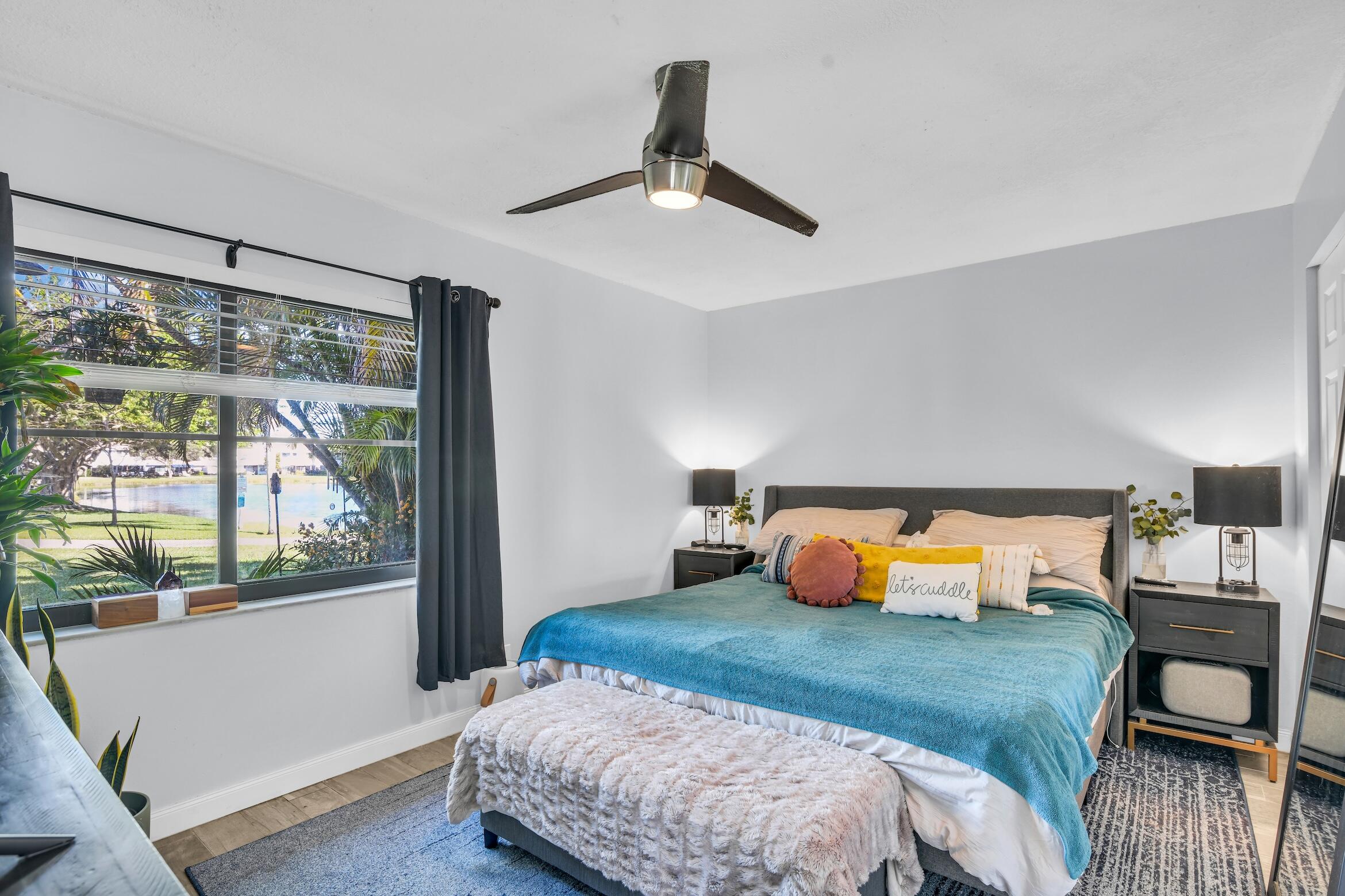 5347 Tennis Lane, Unit 5347 Delray Beach, FL 33484 - Photo 15 of 41 a bedroom with a bed and wooden floor