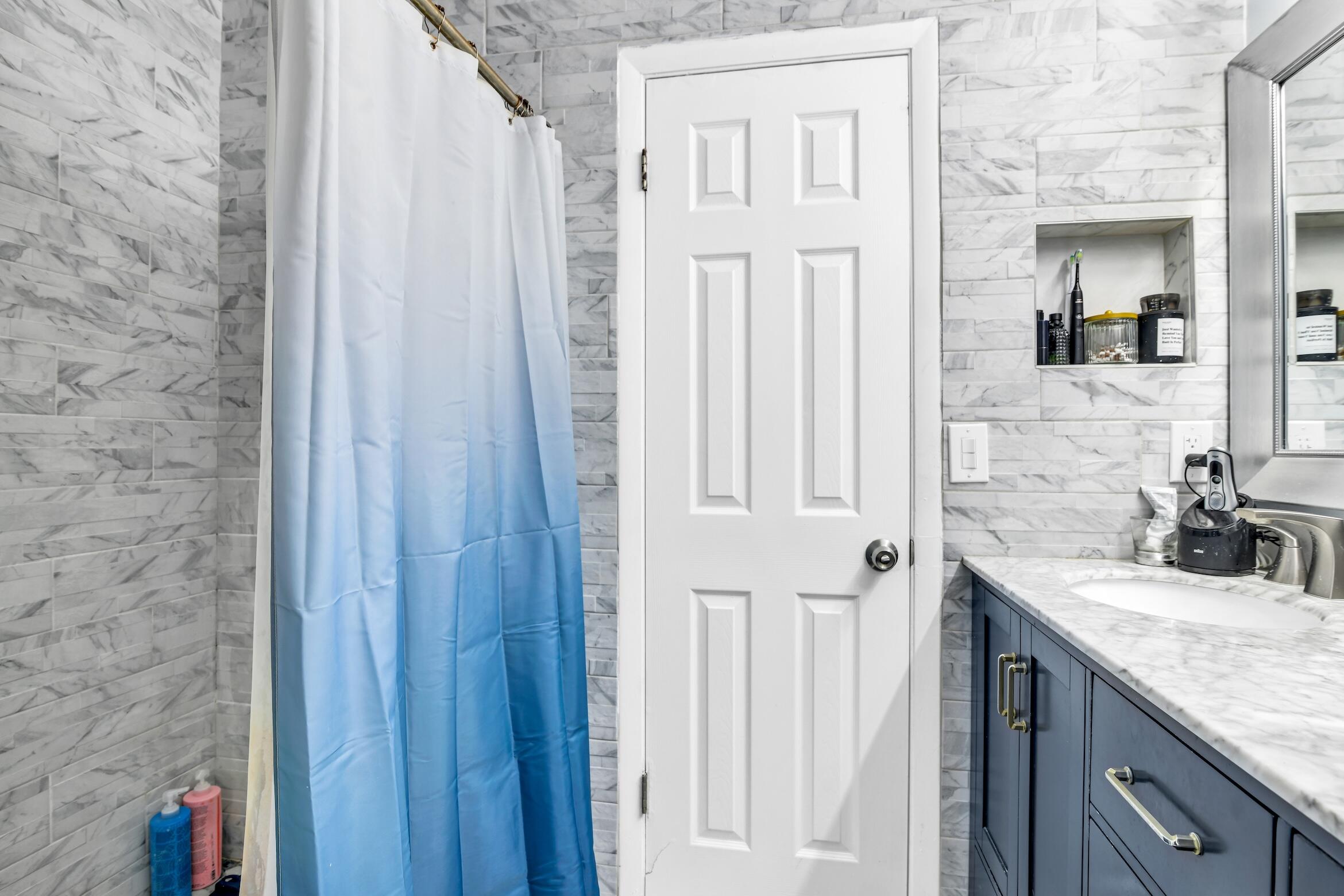 5347 Tennis Lane, Unit 5347 Delray Beach, FL 33484 - Photo 20 of 41 a bathroom with a granite countertop sink and a mirror
