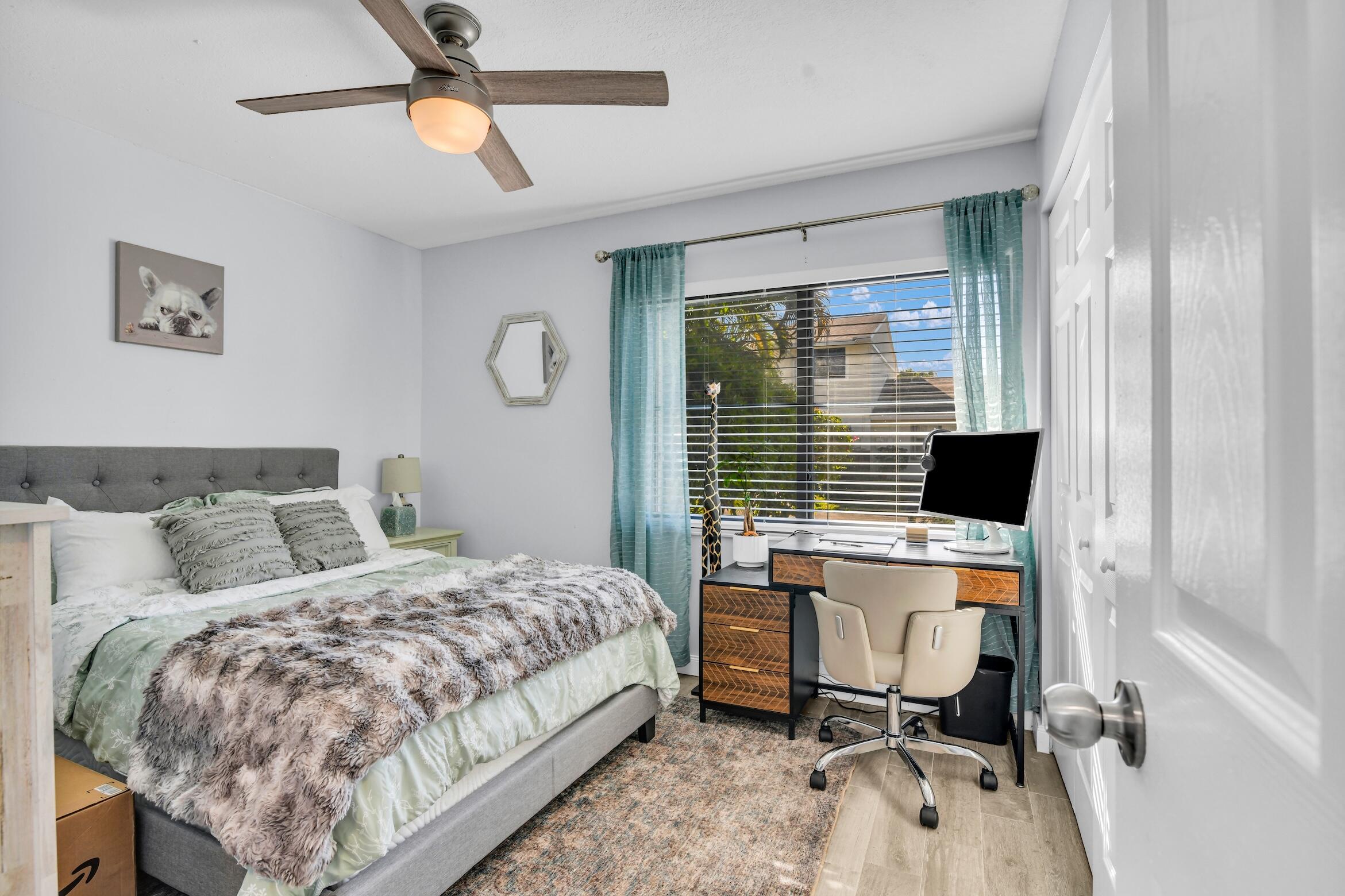 5347 Tennis Lane, Unit 5347 Delray Beach, FL 33484 - Photo 23 of 41 a bedroom with a bed and a desk
