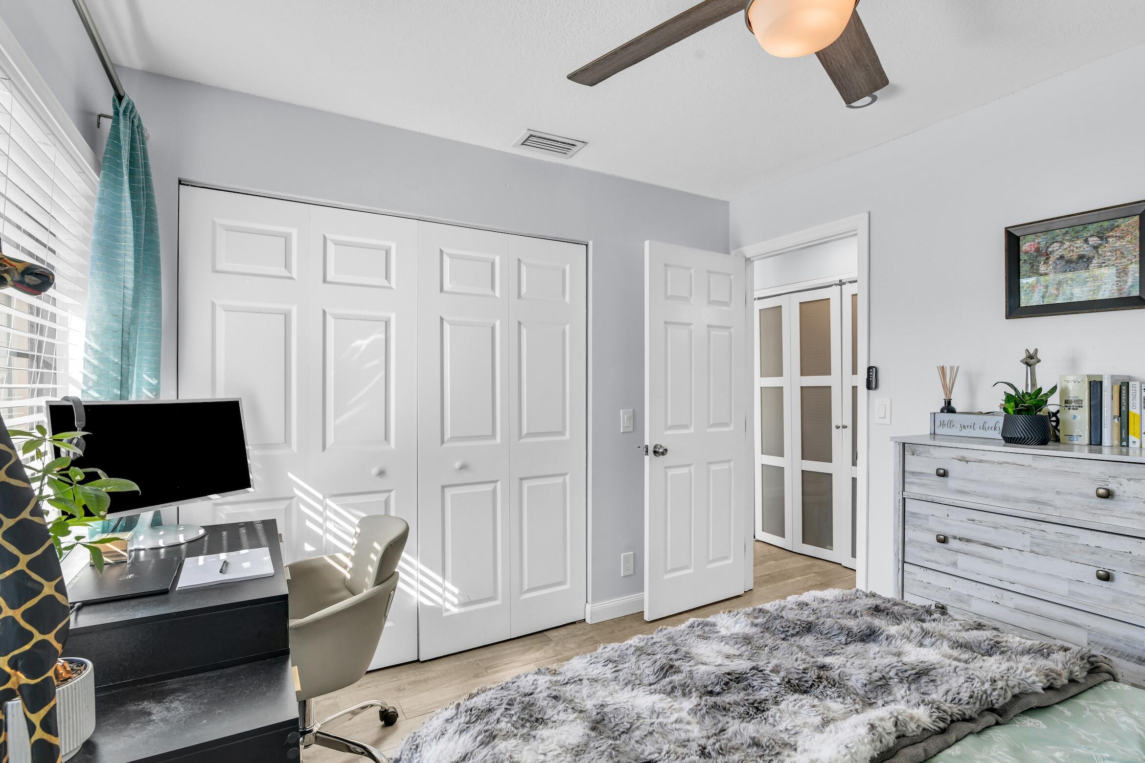 5347 Tennis Lane, Unit 5347 Delray Beach, FL 33484 - Photo 24 of 41 a bedroom with a bed and flat screen tv
