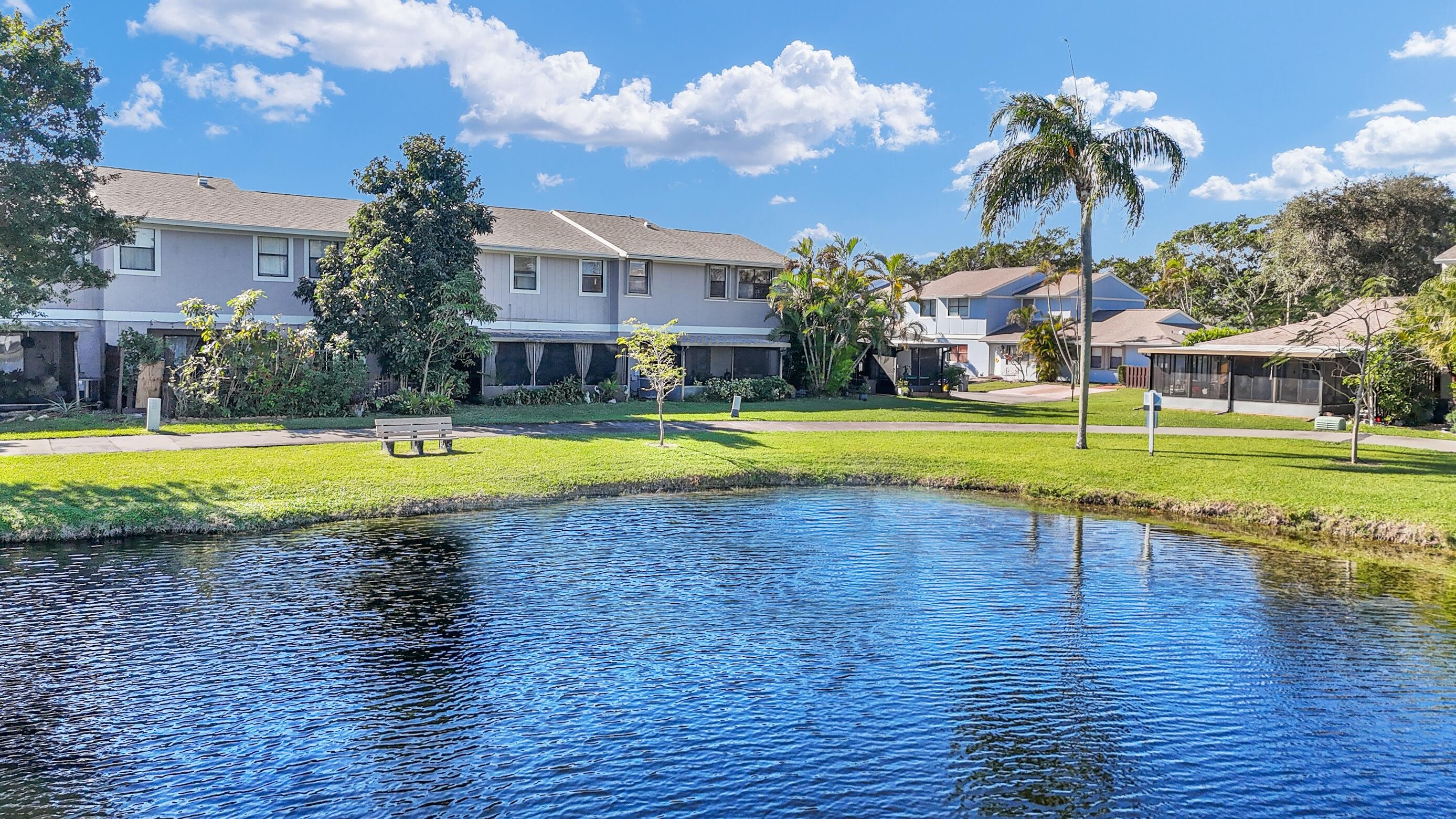 5347 Tennis Lane, Unit 5347 Delray Beach, FL 33484 - Photo 29 of 41 a view of a swimming pool and a yard
