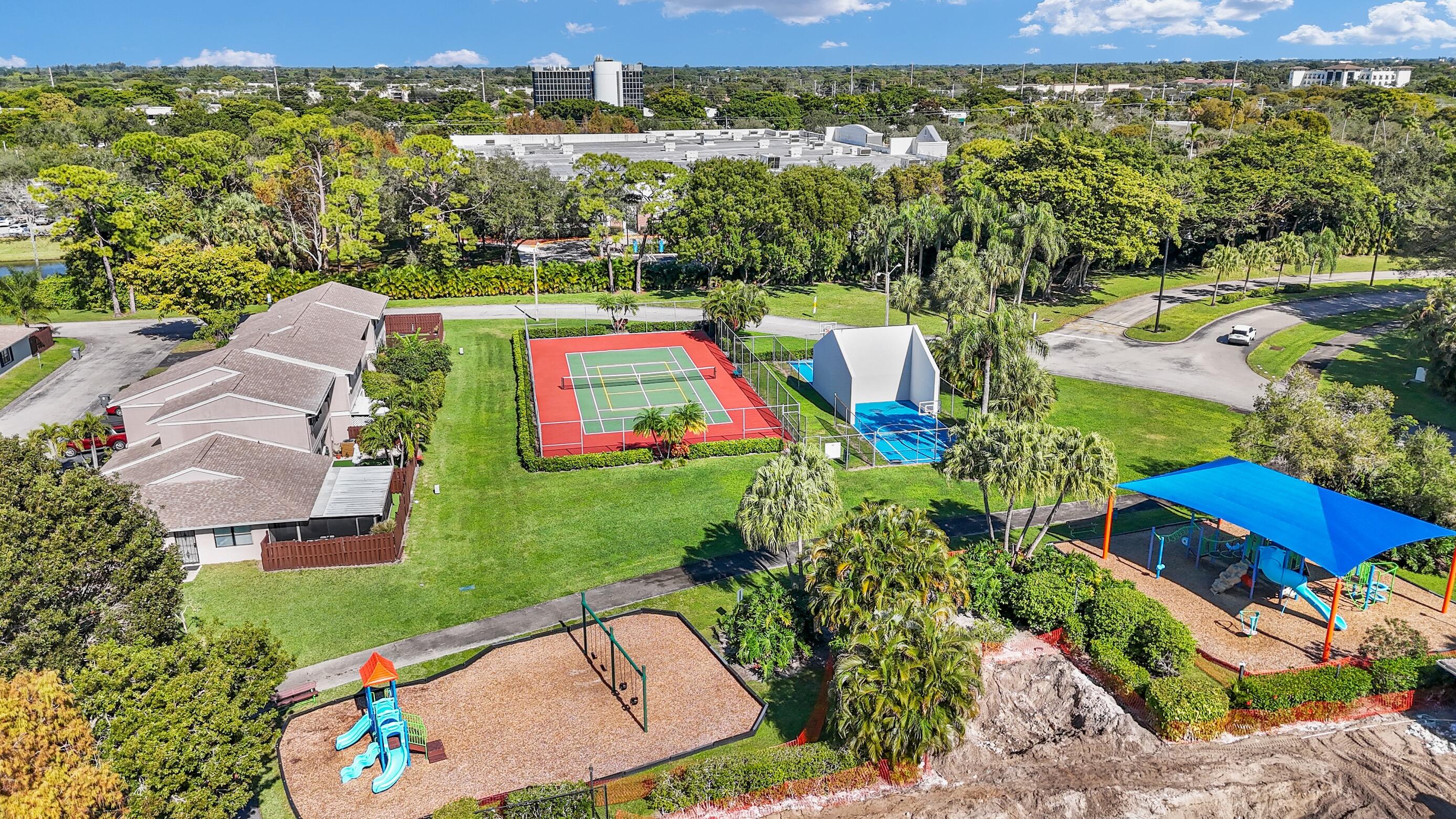 5347 Tennis Lane, Unit 5347 Delray Beach, FL 33484 - Photo 38 of 41 an aerial view of a houses with a swimming pool