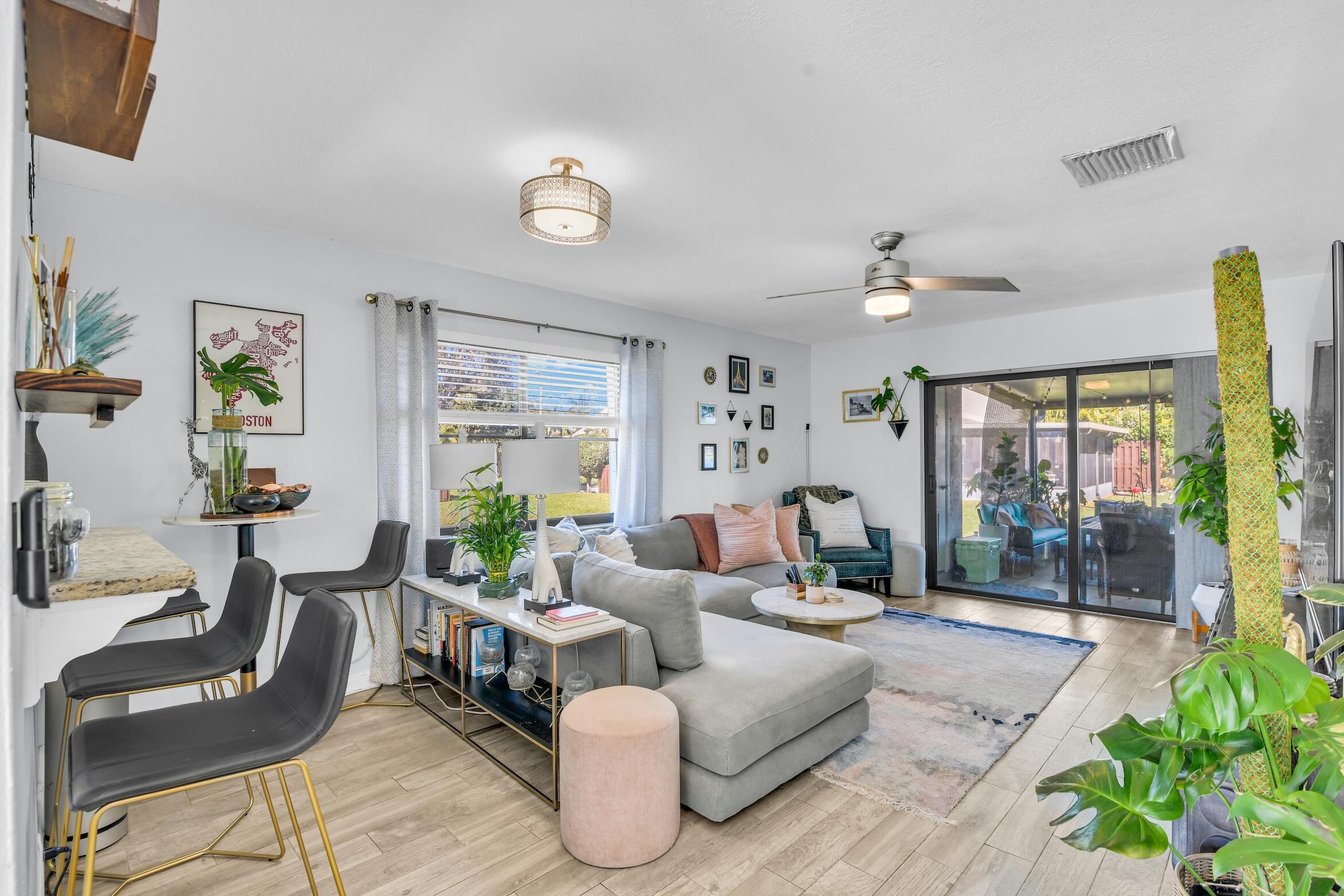 5347 Tennis Lane, Unit 5347 Delray Beach, FL 33484 - Photo 6 of 41 a living room with furniture and a large window