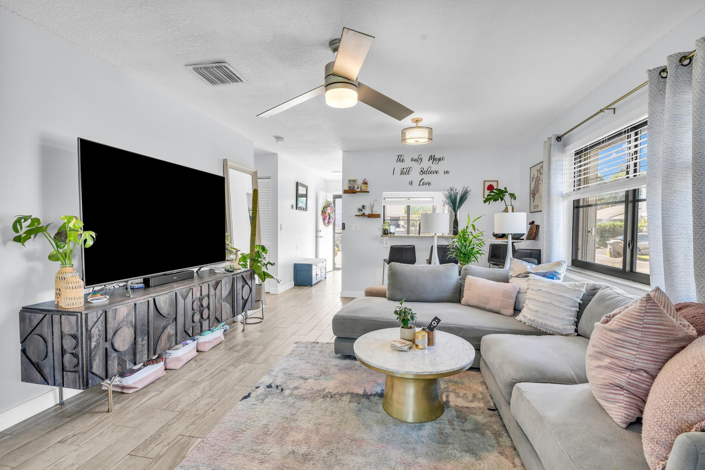 5347 Tennis Lane, Unit 5347 Delray Beach, FL 33484 - Photo 9 of 41 a living room with furniture and a flat screen tv