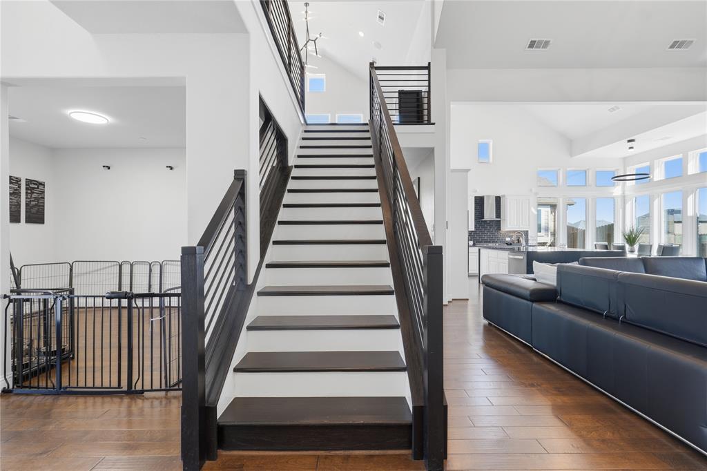 7548 Ridge Lane Grand Prairie, TX 75054 - Photo 4 of 35 Stairs featuring wood-type flooring, a high ceiling, and recessed lighting