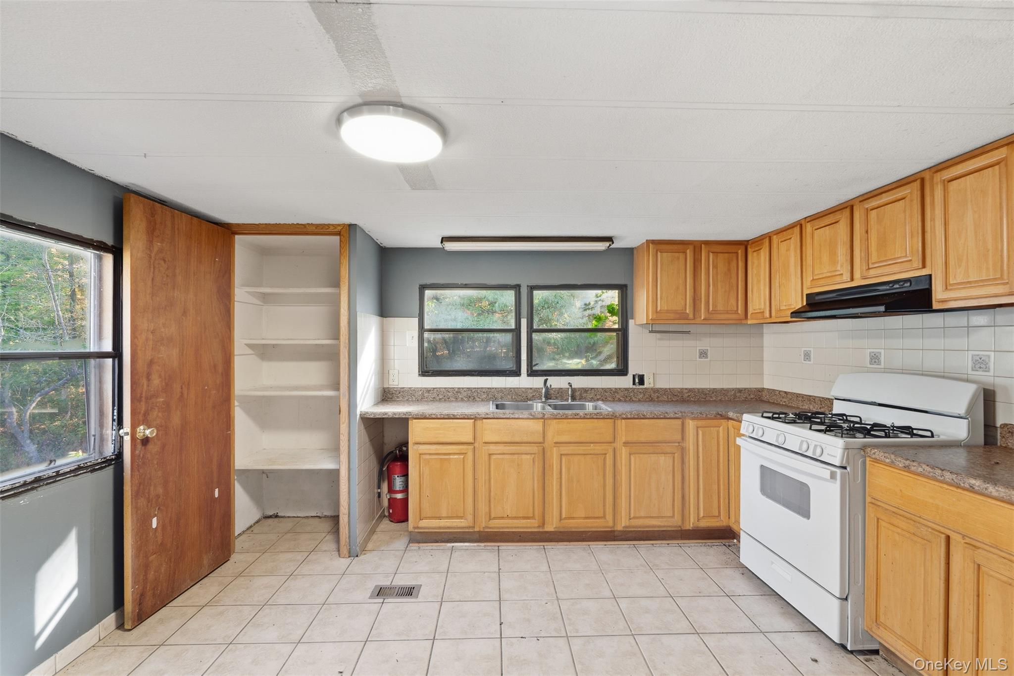 215 Old Rte 32 Highland Mills, NY 10930 - Photo 14 of 34 a kitchen with a stove sink and cabinets