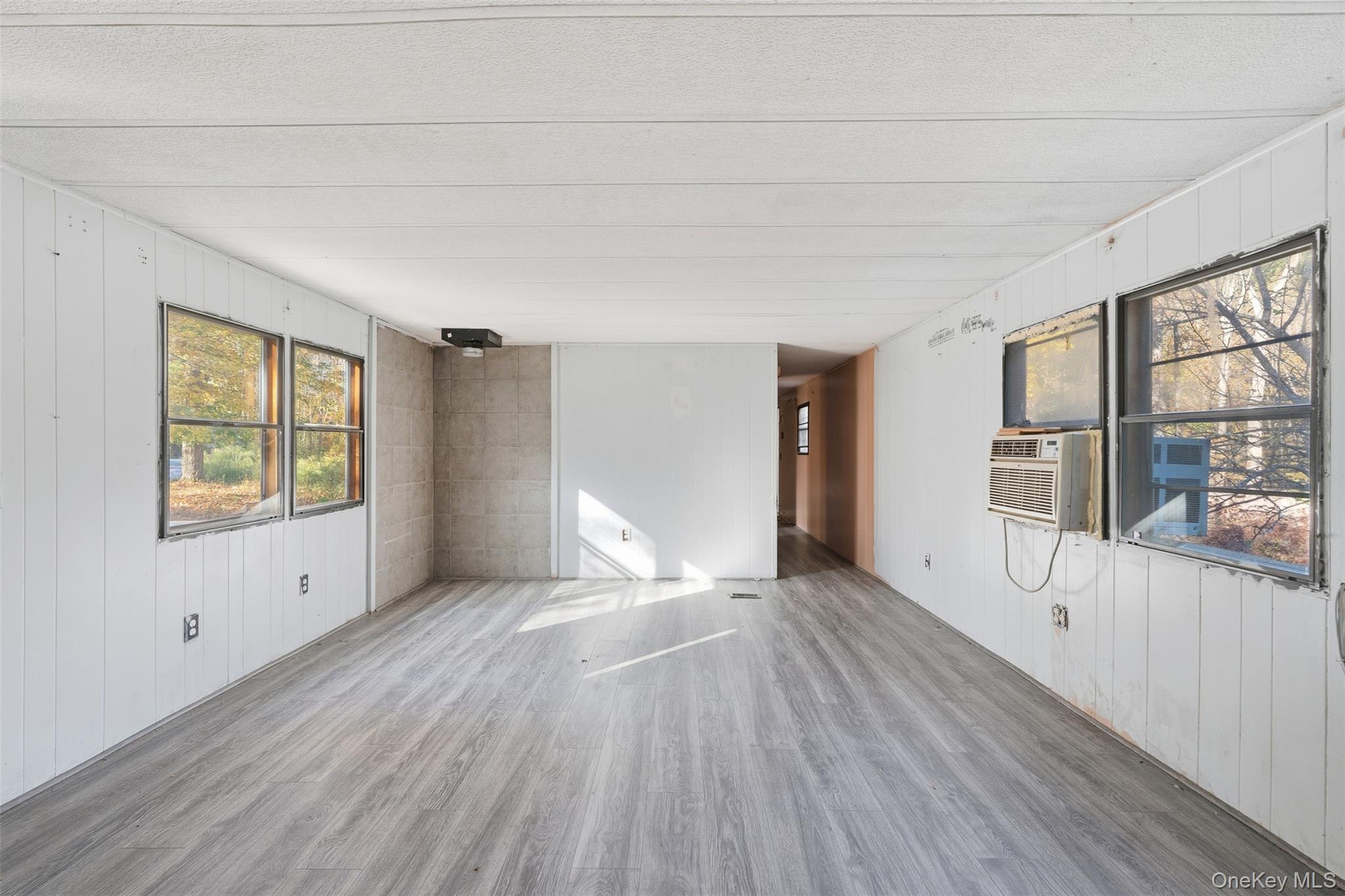 215 Old Rte 32 Highland Mills, NY 10930 - Photo 16 of 34 a view of an empty room with a window and wooden floor