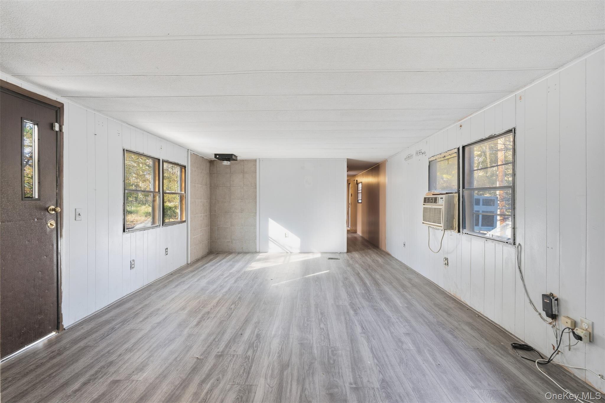 215 Old Rte 32 Highland Mills, NY 10930 - Photo 18 of 34 a view of an empty room with wooden floor and a window