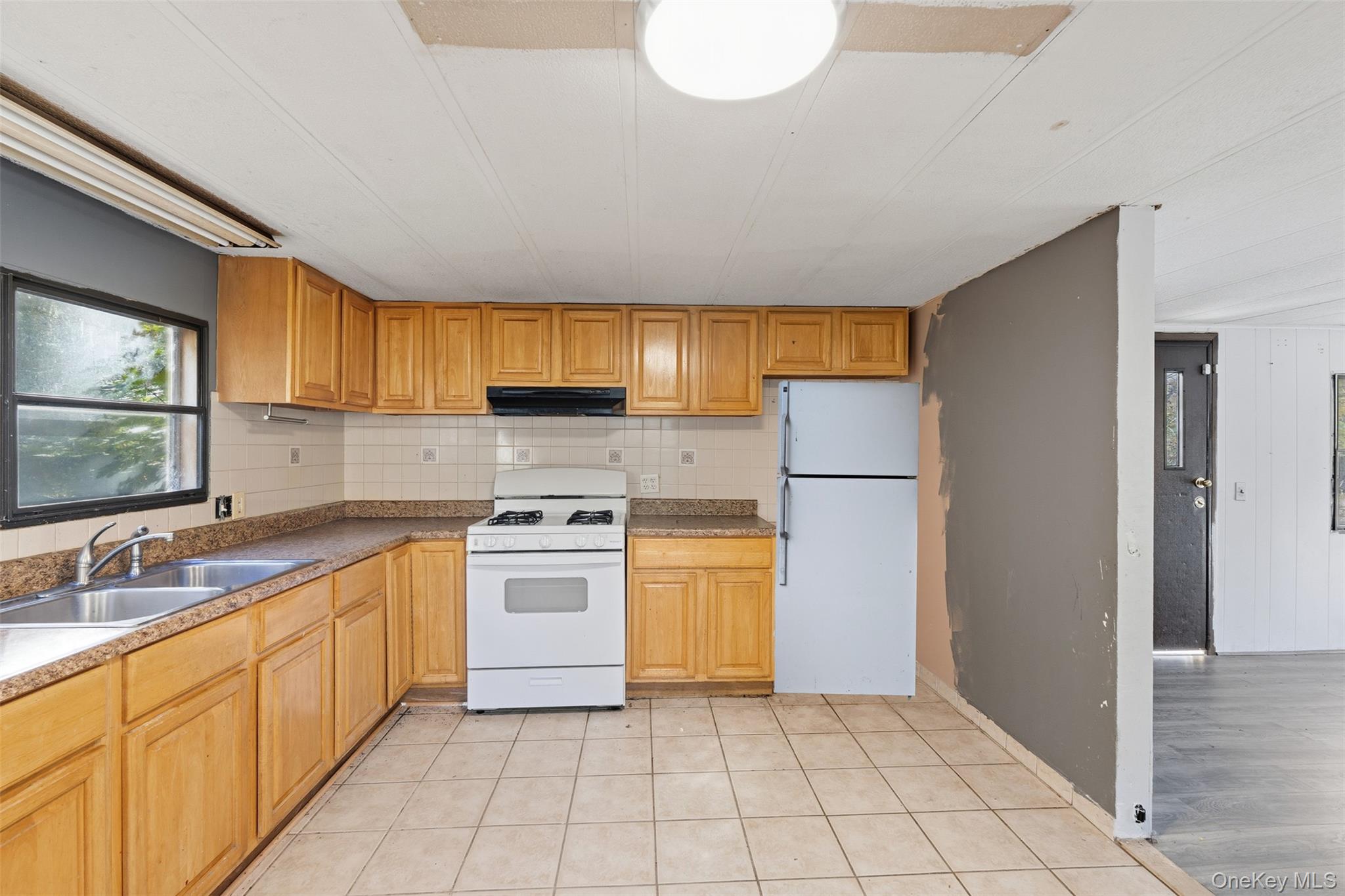 215 Old Rte 32 Highland Mills, NY 10930 - Photo 33 of 34 a kitchen with a refrigerator sink and cabinets