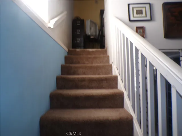 a living room with furniture and stairs