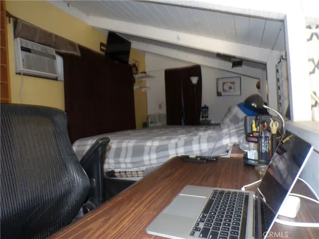 a room with a bed and a mirror