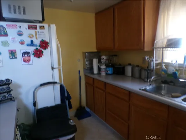 a kitchen with stainless steel appliances granite countertop a stove and a wooden floor